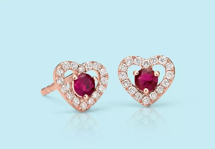 Ruby gemstones set in diamond heart shaped earring studs
